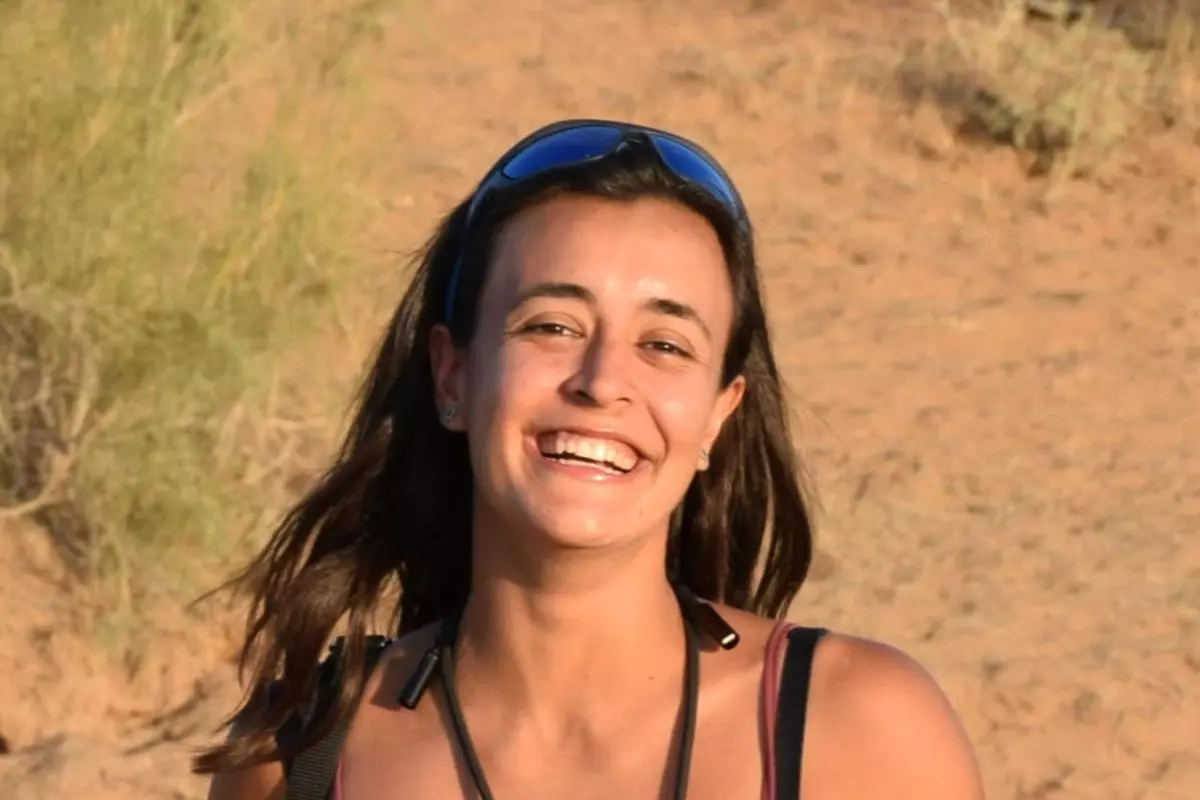 A photo of claudia Di Nunzio, a woman with shoulder length dark hair, laughing